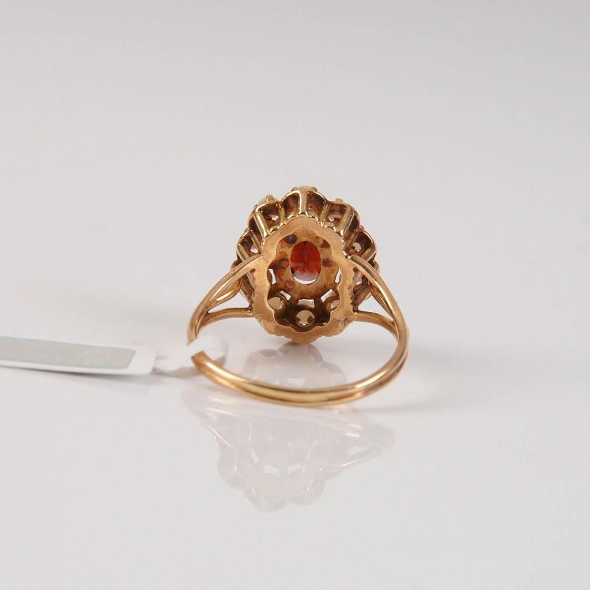 Gold ring with garnet and pearls