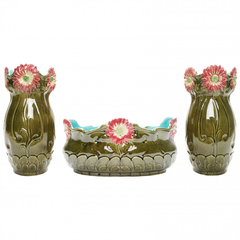 A pair of faience vases with a flower pot