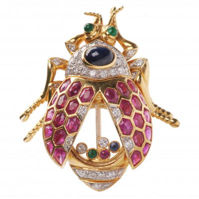 Gold brooch with precious stones in the shape...