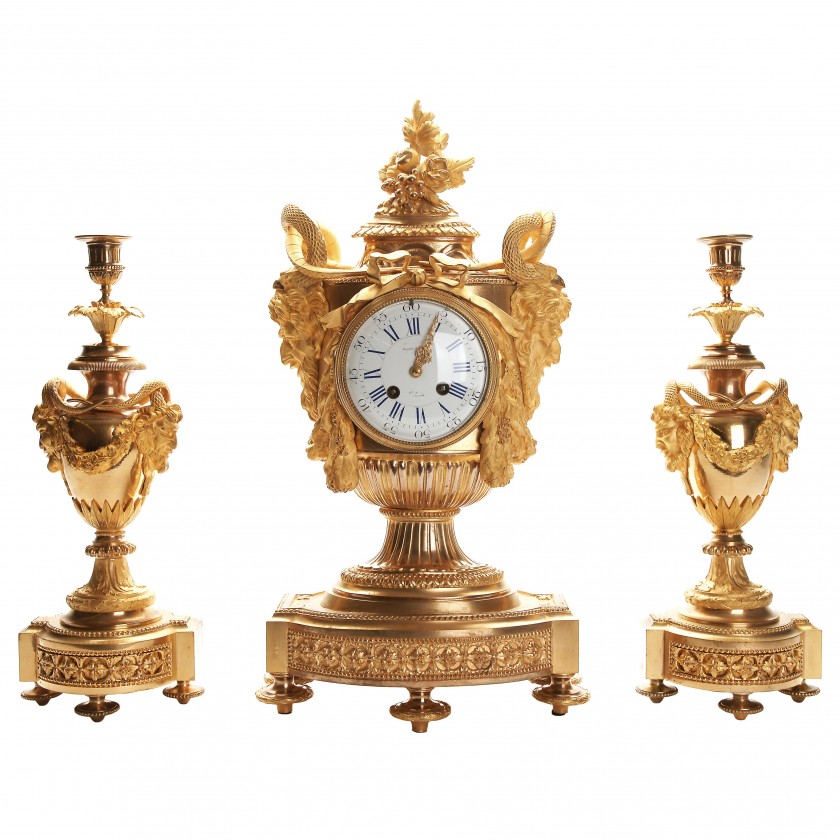 Bronze mantel clock and a pair of candlesticks for one candle