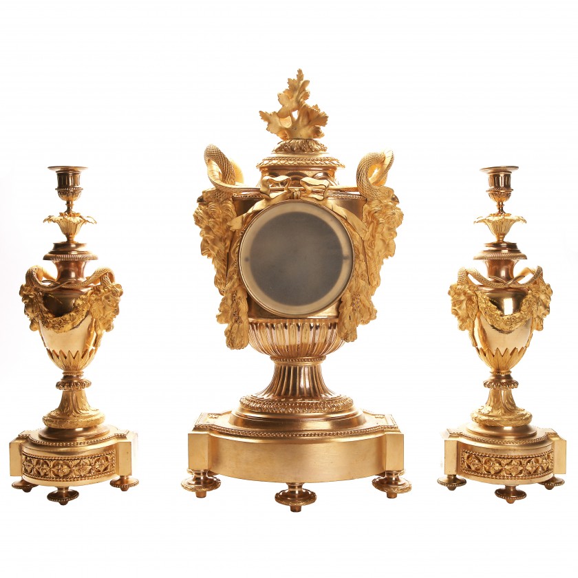 Bronze mantel clock and a pair of candlesticks for one candle