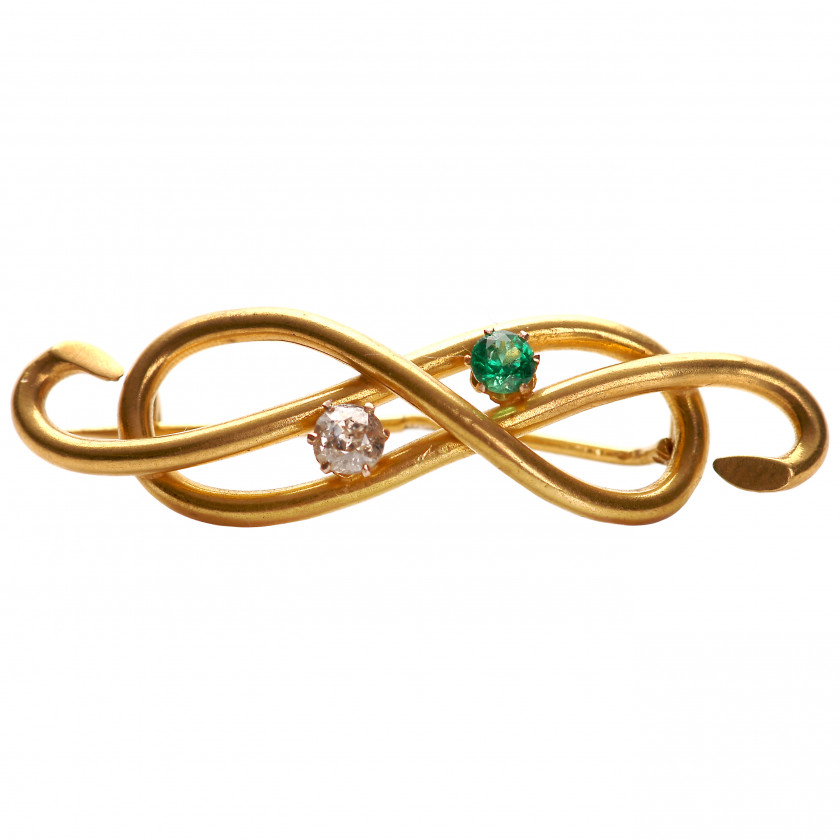 Gold brooch with diamond and emerald