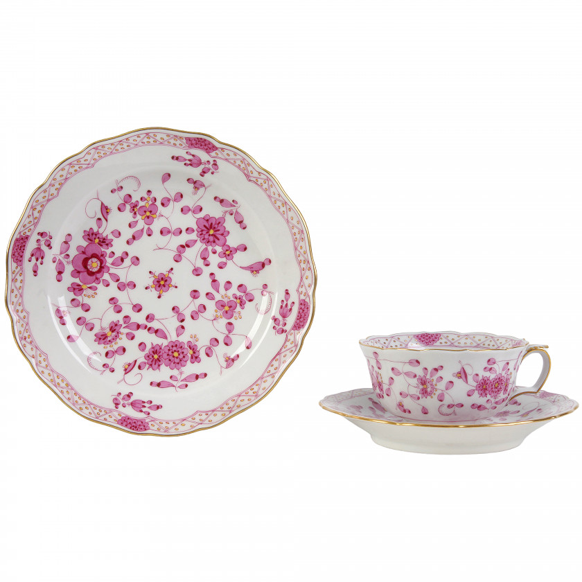 Porcelain tea cup with two saucers