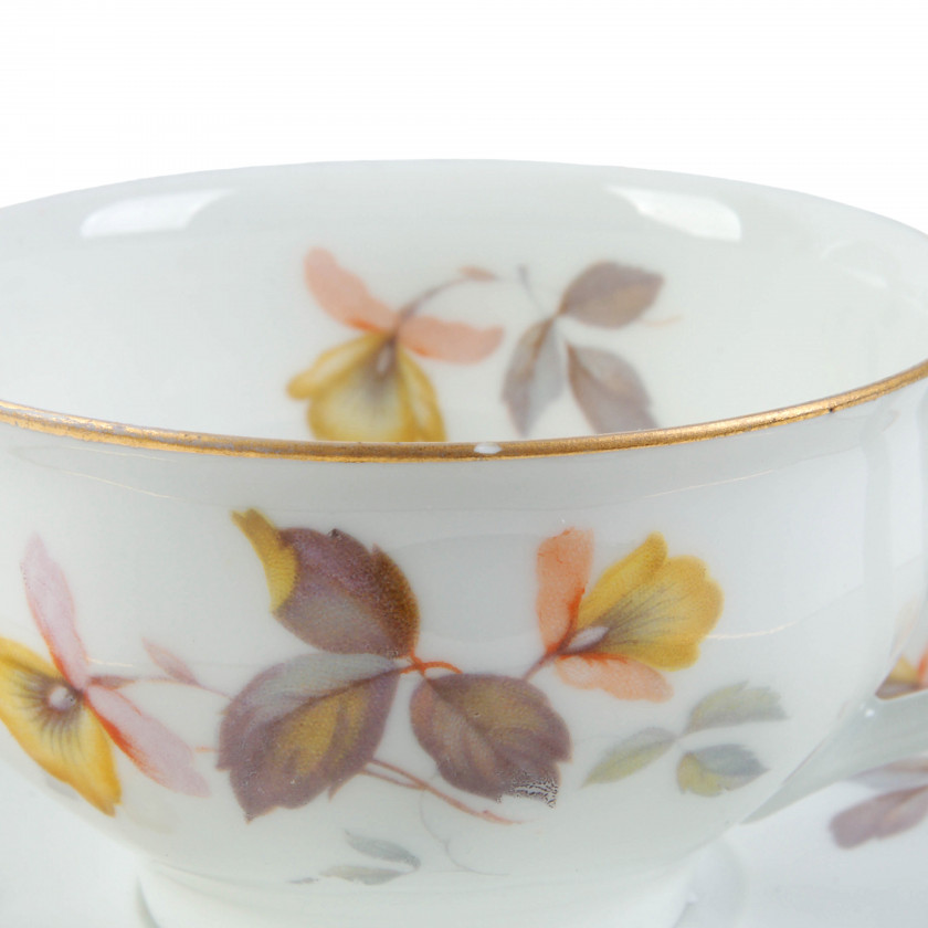 Porcelain tea cup with two saucers