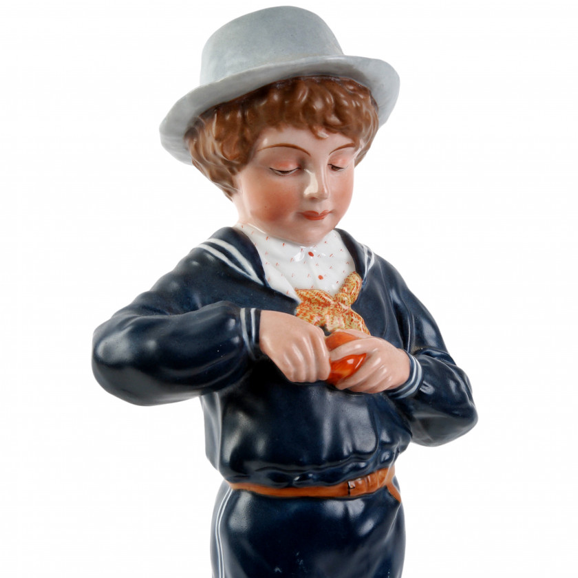 Porcelain figure "Boy peeling an orange"