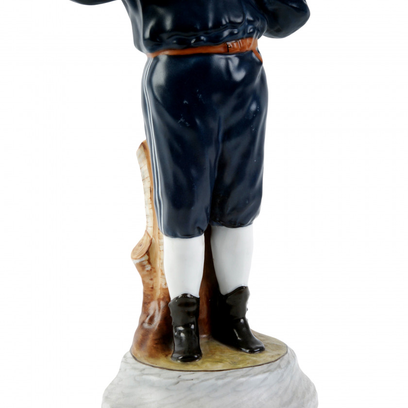 Porcelain figure "Boy peeling an orange"